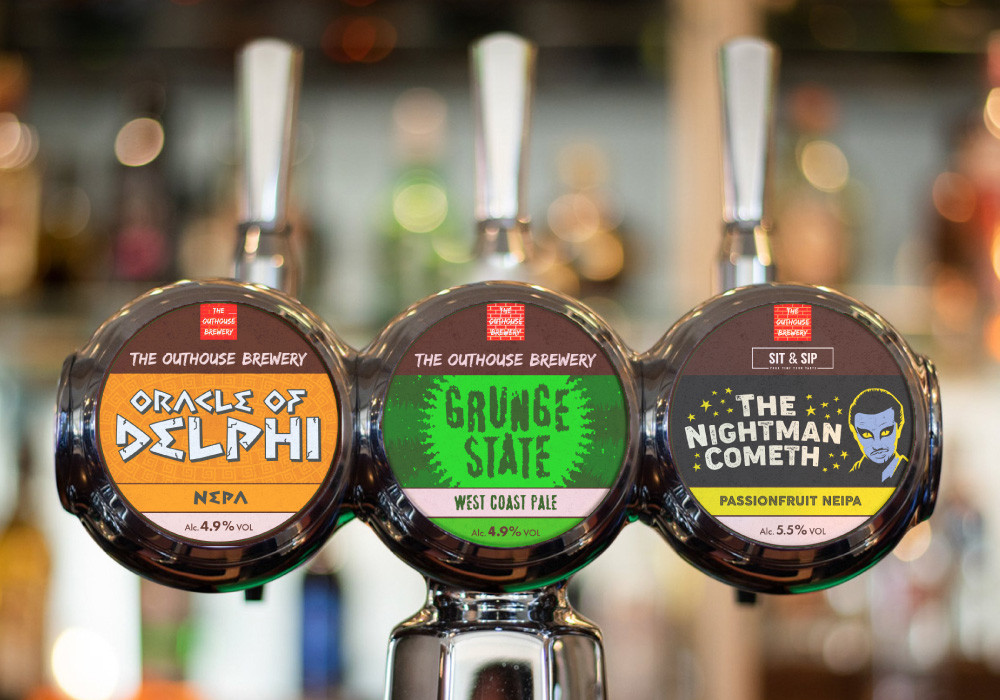 A series of custom keg badge designs for The Outhouse Brewery, blending bold typography and playful illustrations. Created by Creative Footing.